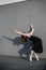 Ballerina in tutu posing standing near the wall. Beautiful young woman in black dress and pointe dancing outside. Gorgeous