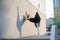 Ballerina in tutu posing standing near the wall. Beautiful young woman in black dress and pointe dancing outside. Gorgeous