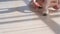 Ballerina in tutu sitting on the floor and tying pointe shoes