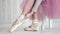 Ballerina tying the pointes. ballet dancer wearing ballet shoes in the studio
