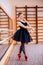 Ballerina Wearing black Tutu Doing exercise in training hall.