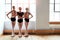 Ballet class is even better with your best friends. a group of young girls practicing ballet together in a dance studio.