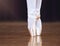 Ballet, dance and shoes with the feet of a ballerina or dancer dancing on a theater stage for a performance or show