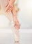 Ballet, dance and shoes of woman on studio floor stretching for art, class and fitness. Creative, training and