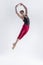 Ballet Dancer. Art Ballet With Young Flexible Athletic Man Posing in Flying Dance Pose With Hands Connected in Studio on White