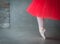 Ballet dancer legs with pointe shoes and coral tutu