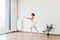 Ballet dancer practice wearing white swan skirt in studio, active lifestyle.