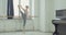 Ballet dancers practicing adagio exercise at barre