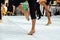 Ballet dancers practicing performance outdoors. Close up of ballerina feet wearing slippers practice moves in ballet class outside