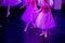 Ballet Dancers under Purple Light with Classical Dresses performing a ballet on Blur Background