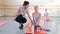 Ballet gymnastic classes, teacher helps girl to practice stretching exercise