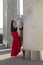 Ballet Ideas. Professional Ballet Dancer in Red Tutu Dress Posing in Red Skirt in Stretching Dance Pose With Lifted Hands and