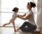 Ballet instructor directs little ballerina during dance practi