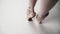 Ballet legs on white background closeup. The ballerina is the graceful gait on Pointe. Slow motion Top view