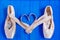 Ballet pointe shoes with ribbons in shape of heart, free space