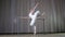 Ballet rehearsal, in old theater hall. Young ballerina in white ballet skirt, tutu, is engaged at ballet, performs