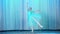 Ballet rehearsal, on the stage of the old theater hall. Young ballerina in blue ballet dress and pointe shoes, dances