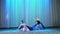 Ballet rehearsal, on the stage of the old theater hall. Young ballerinas in black elegant dresses and pointe shoes