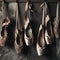 Ballet shoes, old and new, hang on the distressed wall