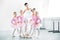 ballet teacher with cute little ballerinas smiling at camera