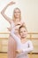 Ballet teacher and her apprentice are holding a