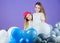 Balloon birthday party. Girls little siblings near air balloons. Birthday party. Happiness and cheerful moments