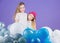 Balloon birthday party. Girls little siblings near air balloons. Birthday party. Happiness and cheerful moments