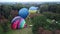 Balloon Festival. Inflating big balloon. Several balloons lie on ground, inflate