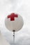 Balloon first aid red cross sign outside