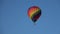 A balloon flies in the evening blue sky