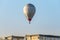 Balloon flies next to parachute . extreme sport