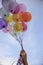 Balloon Hand in Happy birthday party sky background with string and ribbon helium Ballon floating in celebrate wedding day.Concept