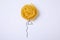 Balloon made with tagliatelle pasta on background, top view