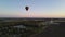 balloon moves against the background of the setting sun in the evening. aerial sunset