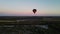 balloon sits down smoothly at sunset