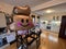 Balloon with a smiley face hangs in the kitchen near the table