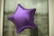 Balloon star. Purple inflatable ball. Star on window