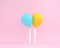 Balloons blue and yellow pastel with white legs woman on pink co