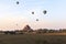 Balloons over Bagan at sunrise with horses