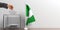 Ballot box and a small Nigeria flag. 3d illustration