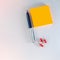 Ballpoint pen and stack of orange neon self-adhesive stickers and three red chalkboard pins lie on a light background. Business