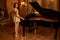 Ballroom, woman and elegant portrait with piano, musician back and mansion ready for music performance. Entertainment