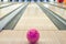 Balls on bowling alley against ten pins