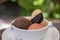 Balls of chocolate, strawberry and mango ice cream with cookies in a white bowl, closeup