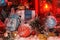 Balls and Christmas bell are covered with snow in the light of a red lantern on the background of New Year`s scenery