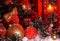 Balls and Christmas bell are covered with snow in the light of a red lantern on the background of New Year`s scenery