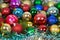 Balls colorful bright Christmas with green branches of spruce and shiny tinsel. Toys, New year