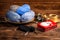Balls of gray and blue threads in a wooden plate, Christmas decorations and a metal box with a picture of Santa Claus knitting