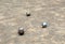Balls of petanque on the sand during the game.