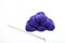 Balls of purple knitting wool and needles